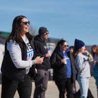 Girl smiling during corn hole game